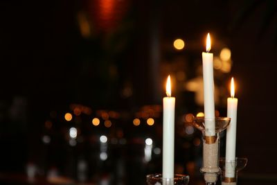 Close-up of lit candles at night