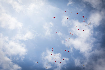 Low angle view of balloons against sky