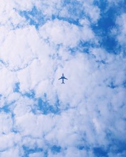 Low angle view of airplane flying in sky