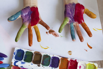 Directly above shot of painter hands over table