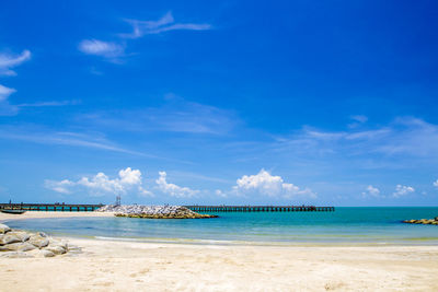 Scenic view of beach against blue sky