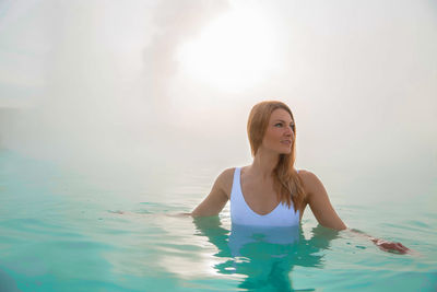 Portrait of young woman in swimming pool