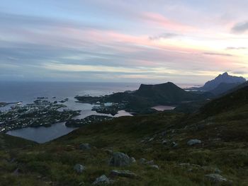 Scenic view of sea and mountains against sky