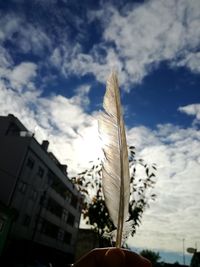 Low angle view of building against cloudy sky