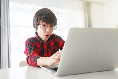 Boy using laptop at home