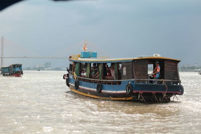 Boat sailing in sea against sky