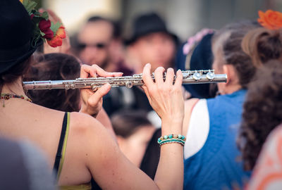 Woman playing flute during event