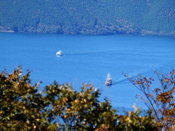 Sailboat in sea against sky