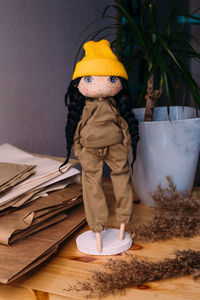 Man sitting on table against wall