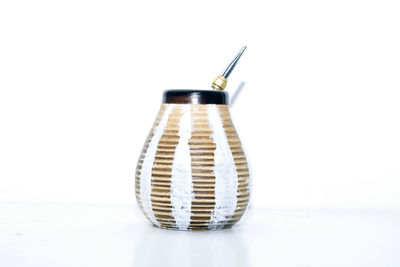Close-up of jar against white background