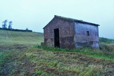 View of abandoned house against clear sky