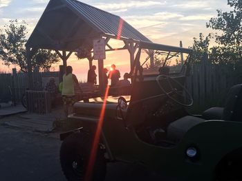 Side view of cars parked at sunset