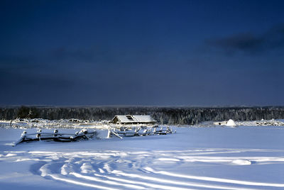 Scenic view of snow covered field against sky