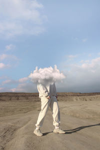 Full length of man standing on sand dune