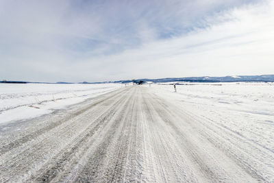 Scenic view of snow covered landscape against sky