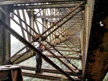 Man seen through railing