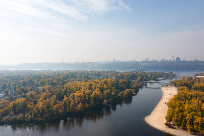 Autumn view of the dnieper river in kiev and the city center on the horizon with a large park