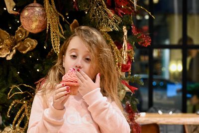 Portrait of girl having cupcake 