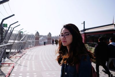 Portrait of woman standing against sky