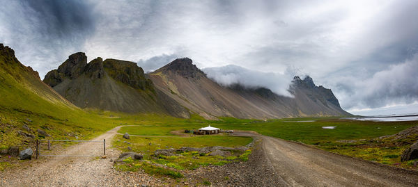 Panoramic view of road amidst mountains against sky