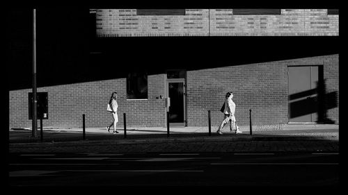 Men standing on wall