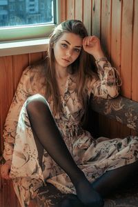 Portrait of young woman sitting outdoors