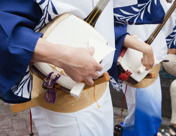 Midsection of woman holding stick