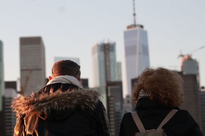 Rear view of people in city