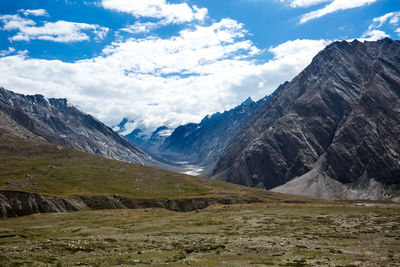 Scenic view of mountains against cloudy sky