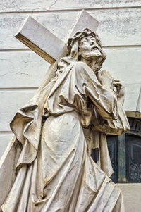 Low angle view of angel statue against temple