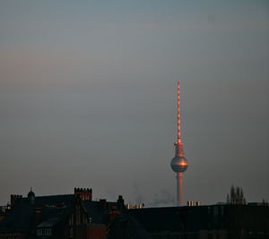 Communications tower in city at night