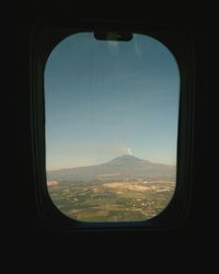 Scenic view of landscape seen through airplane window