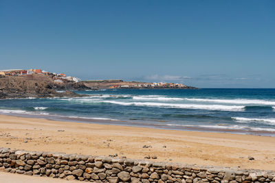 Scenic view of sea against clear blue sky