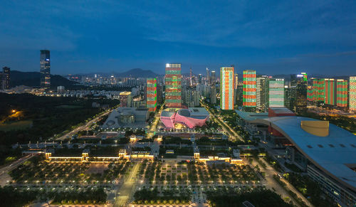 High angle view of illuminated buildings against sky at night