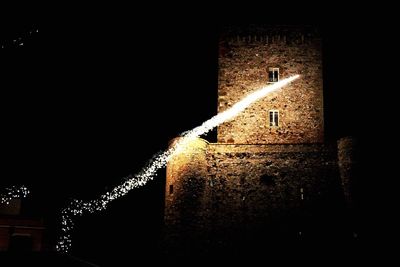 Low angle view of illuminated building at night