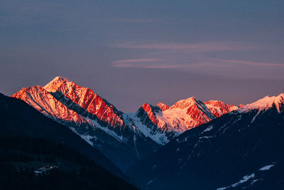 Scenic view of snowcapped mountains against sky during sunset