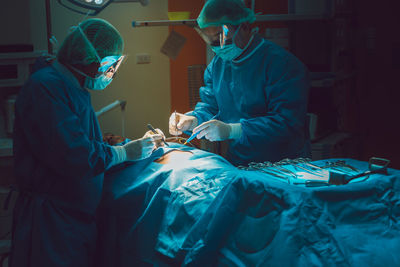 Doctors doing surgery of patient in operating room
