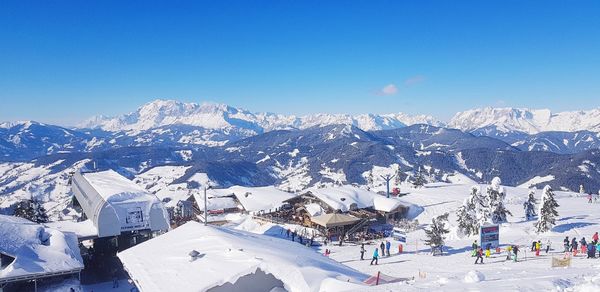 Scenic view of snowcapped mountains against blue sky