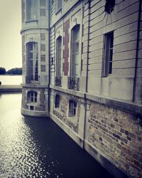 Building by canal in city