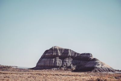 Built structure on sand against clear sky