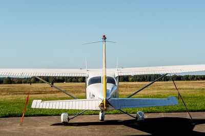 Airplane on runway against clear sky