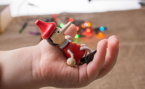 Close-up of human hand holding figurine