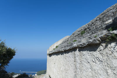 Low angle view of mountain against clear blue sky