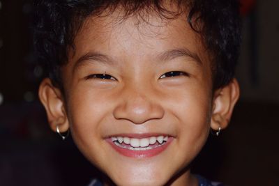 Close-up portrait of smiling baby girl at home