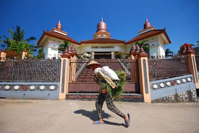 Full length of woman outside temple against building