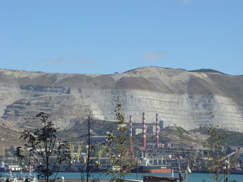 View of buildings in city against blue sky