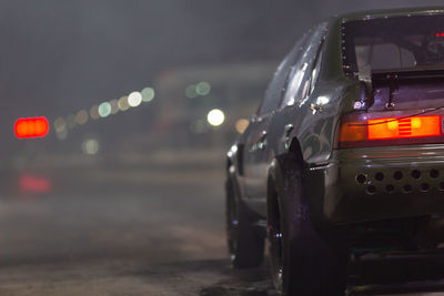 Drag racing car at the start competition at night, drag race car in race track at night.