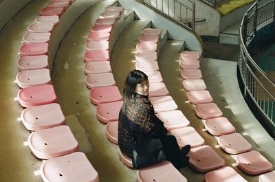 High angle view of woman standing on spiral staircase