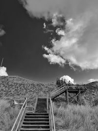 Staircase on field against sky