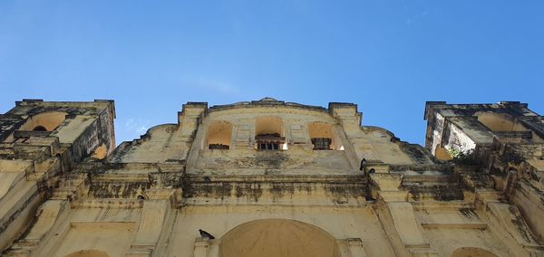 Low angle view of buildings against blue sky